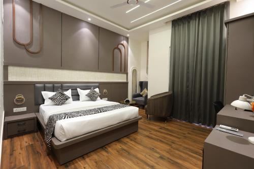 a hotel room with a bed and a sink at Hotel Marina in Meerut