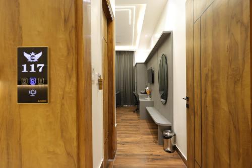 a hallway of a bathroom with sinks and toilets at Hotel Marina in Meerut