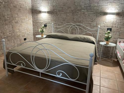 a bedroom with a metal bed with two tables at Il Rifugio nel Matese in San Massimo