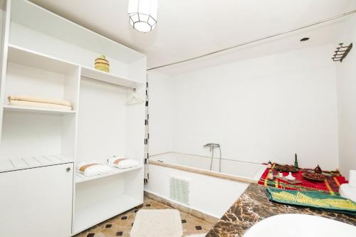 a bathroom with white cabinets and a sink at Riad Saida Atlas in Marrakesh