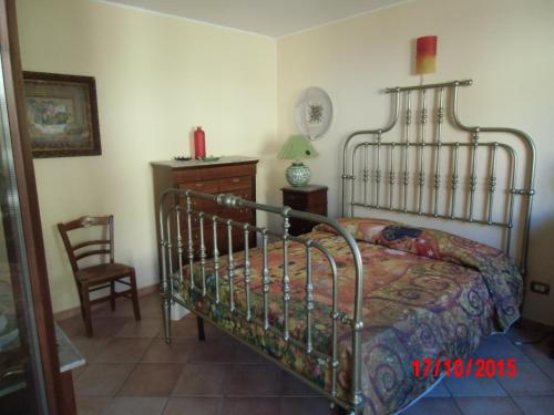 ポルティチェッロにあるHoliday home Santa Flavia 2のベッドルーム(金属製ベッド1台、椅子付)