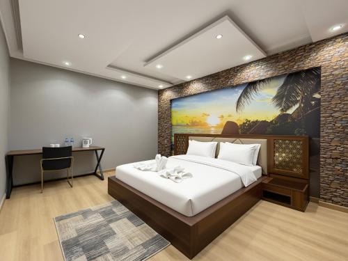 a bedroom with a large bed and a desk at JubingeHotel 聚滨阁华人酒店 in Cairo