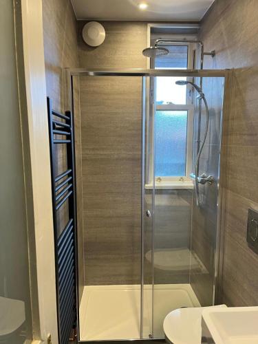 a shower with a glass door in a bathroom at Seabreeze in North Berwick