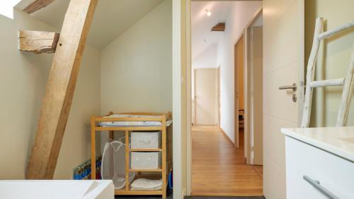 an attic bathroom with a staircase and a hallway at Gîte La Longère in Laillé