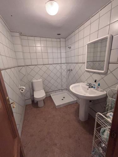 a bathroom with a sink and a toilet at Casa Familiar Mazalvete in Mazalvete