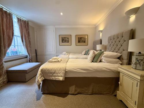 a bedroom with a large bed and a window at Abbey Mews in Bath