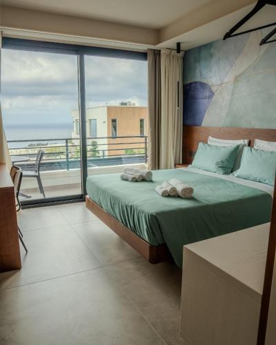 a bedroom with a bed and a large window at Daga Resort in Zambrone