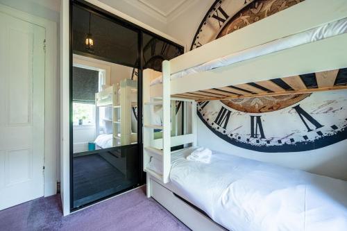a bedroom with a bunk bed and a mirror at Culzean Road, Retreat in Maybole