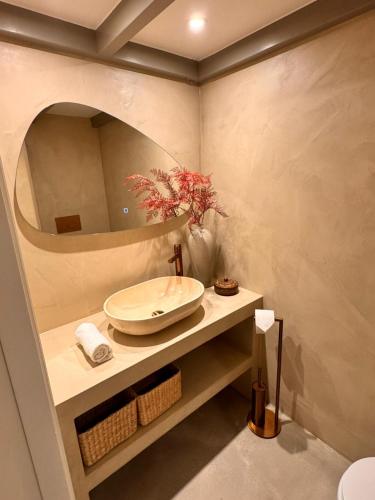 a bathroom with a sink and a mirror at New monumental garden view Studio in Amsterdam