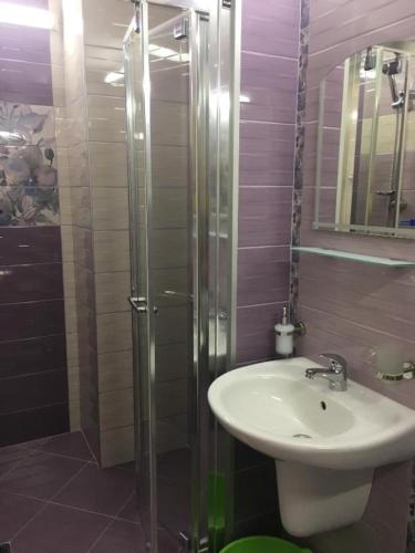 a bathroom with a sink and a shower at goldenseaview in Pomorie