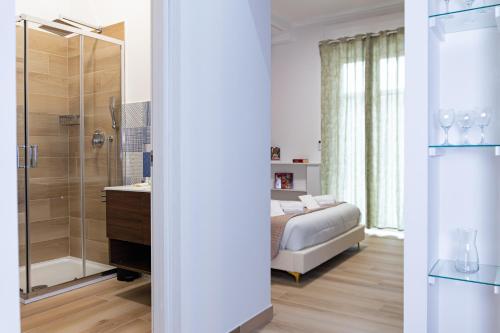 a bedroom with a bed and a shower and a bathroom at Salerno Stay in Salerno