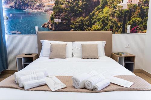 a bedroom with a bed with towels on it at Salerno Stay in Salerno