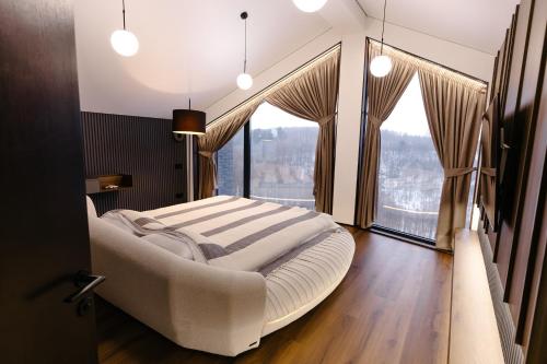 a bedroom with a large bed and a large window at Liso Prostir in Lisopotik
