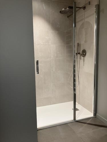 a shower with a glass door in a bathroom at Coasteres T2 in Trébeurden