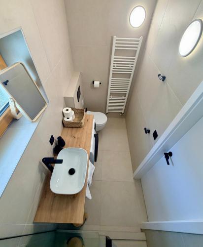 a small bathroom with a sink and a toilet at Apartmán Štúr Trenčín Centrum in Trenčín