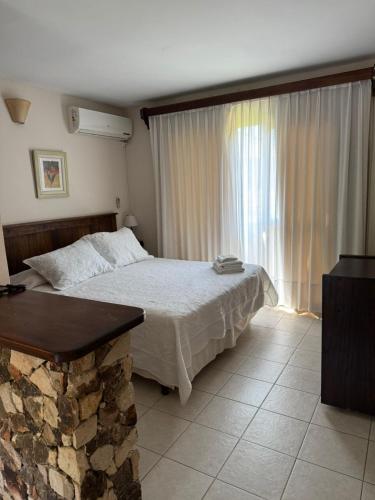 a bedroom with a bed and a large window at Villa Ostende Apart Hotel & Spa in Ostende