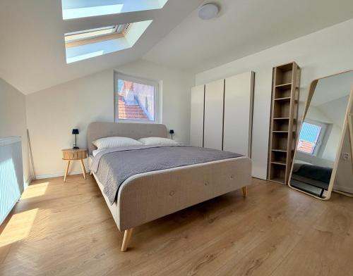 a bedroom with a large bed and a skylight at Apartmán Štúr Trenčín Centrum in Trenčín