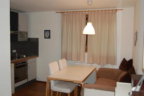a kitchen and dining room with a table and a couch at Landhaus Neussl in Kaltenbach