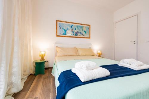 a bedroom with a bed with towels on it at GuestHost - Barni House in Montesilvano