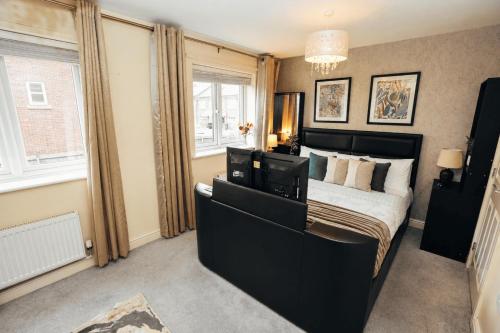 a bedroom with a large bed and a window at 4-Bedroom Family Home in Mickleover - Private Driveway - Spacious Garden in Derby
