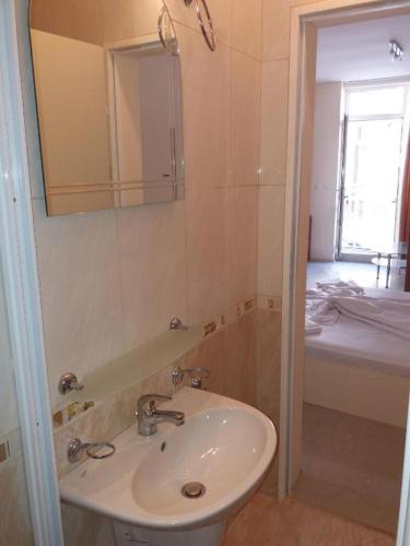 a bathroom with a sink and a mirror at goldenseaview apartment 2 in Pomorie