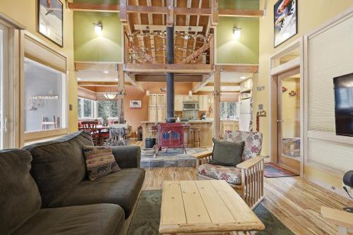 a living room with a couch and a table at A-Frame Home with Deck & BBQ - VH223 cabin in Bear Valley