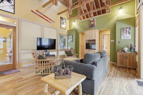a living room with a couch and a tv at A-Frame Home with Deck & BBQ - VH223 cabin in Bear Valley