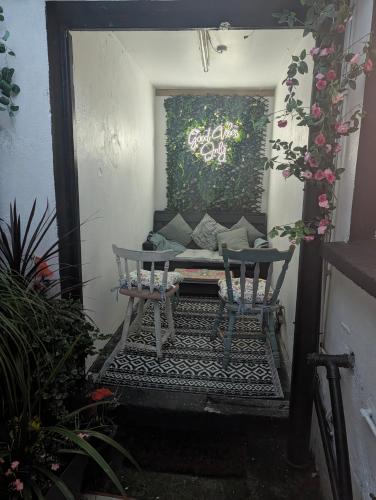a patio with two chairs and a couch at Ivy Townhouse Derry in Derry Londonderry