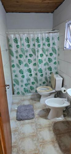 a bathroom with two toilets and a shower curtain at NEUQUEN alojamiento in Neuquén