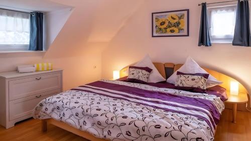 a bedroom with a bed with pillows on it at Ferienwohnung Daun in Daun