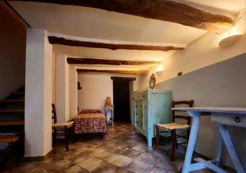 a room with a bed and a table and chairs at Under The Tuscan Sun in Monterotondo