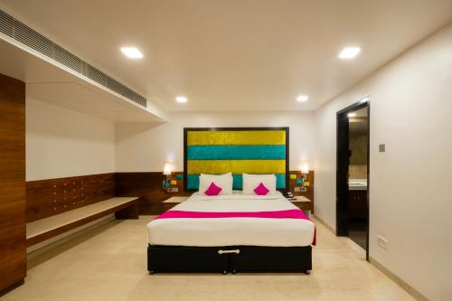 a bedroom with a large bed in a room at La Woods Hotel in Chennai