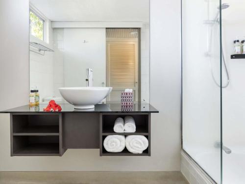 a bathroom with a sink and a mirror at Mercure Nadi in Nadi