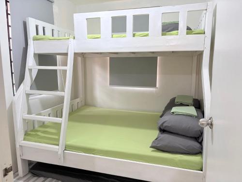 a bunk bed with a sleeping bag in a room at Santiago City Transient House in Santiago