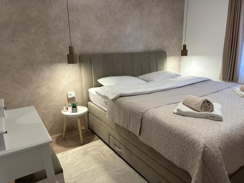 a bedroom with a bed with a towel on it at Novi apartman Posušje in Posušje