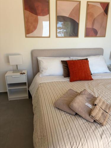 a bedroom with a bed with two pillows on it at Attico Terracotta in Borgo Bainsizza