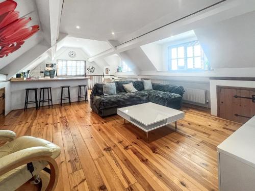 a living room with a couch and a table at The Flat The Farm in Godstone