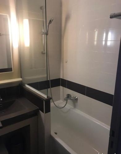 a bathroom with a shower and a tub and a sink at Cocon dans le village cap esterel in Saint-Raphaël