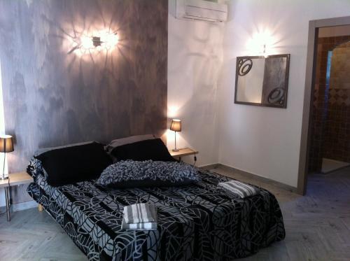 a bedroom with a bed and two lights on the wall at Domaine Casa Andria in Barbaggio