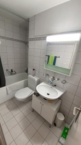 a bathroom with a sink and a toilet and a mirror at Charmantes Studio in Solothurn