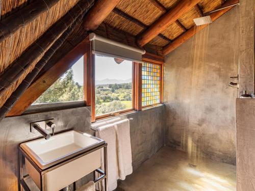a bathroom with a sink and a window at Mountain Cabin private hot tub and swimming pool in Wolseley
