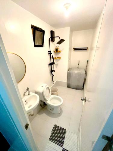 a bathroom with a toilet and a sink at The JOYful Stay in Mactan Island