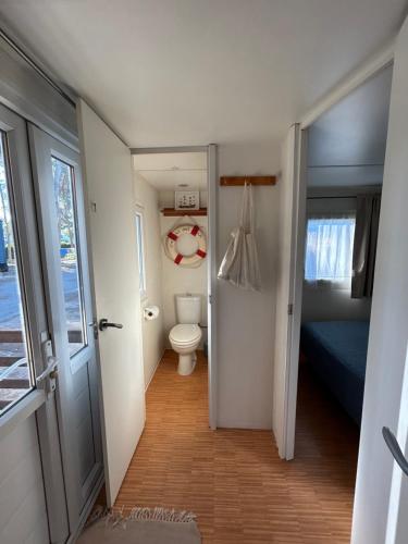 a small bathroom with a toilet and a bedroom at El Moll Grec in L'Escala