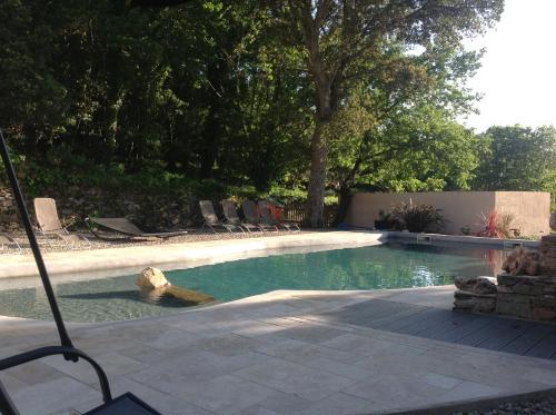 a swimming pool with chairs in a yard at Domaine Casa Andria in Barbaggio