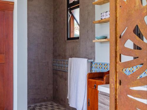 a bathroom with a shower with white towels at Mountain Bungalow private hot tub&swimming pool in Wolseley