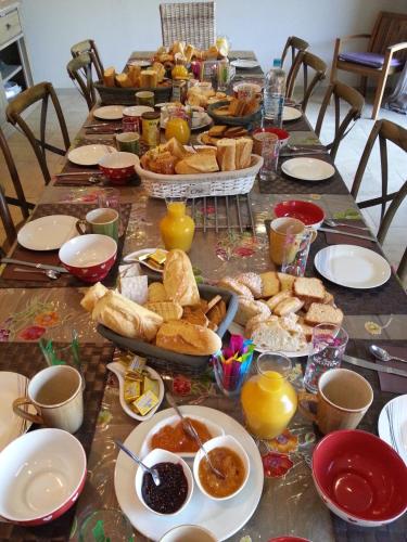 a long table with food and bread on it at Domaine Casa Andria in Barbaggio