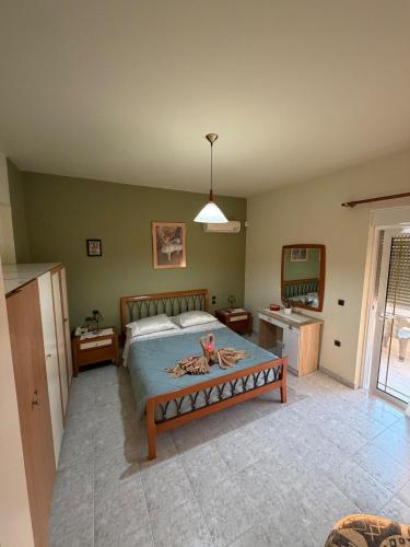 a bedroom with a bed and a table in it at Silver View House in Theologos