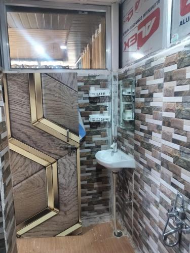 a bathroom with a sink and a mirror at Adaara Retreat - Pet Friendly Cottages, Almora in Almora