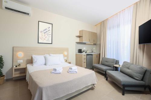 a hotel room with a bed and a chair at Suel Suites Afitos in Afitos