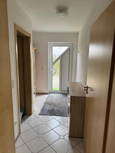 an empty room with a door leading to a hallway at Anjas Ferienwohnung Buchenrod in Flieden